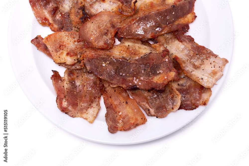 Cooked slices of bacon on white ceramic plate isolated on white background Cooked slices of bacon on white ceramic plate isolated on white background