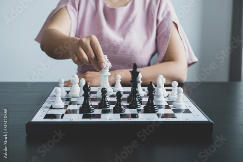 Hand of businesswoman moving, chess in competition shows leadership, followers, and business success strategies