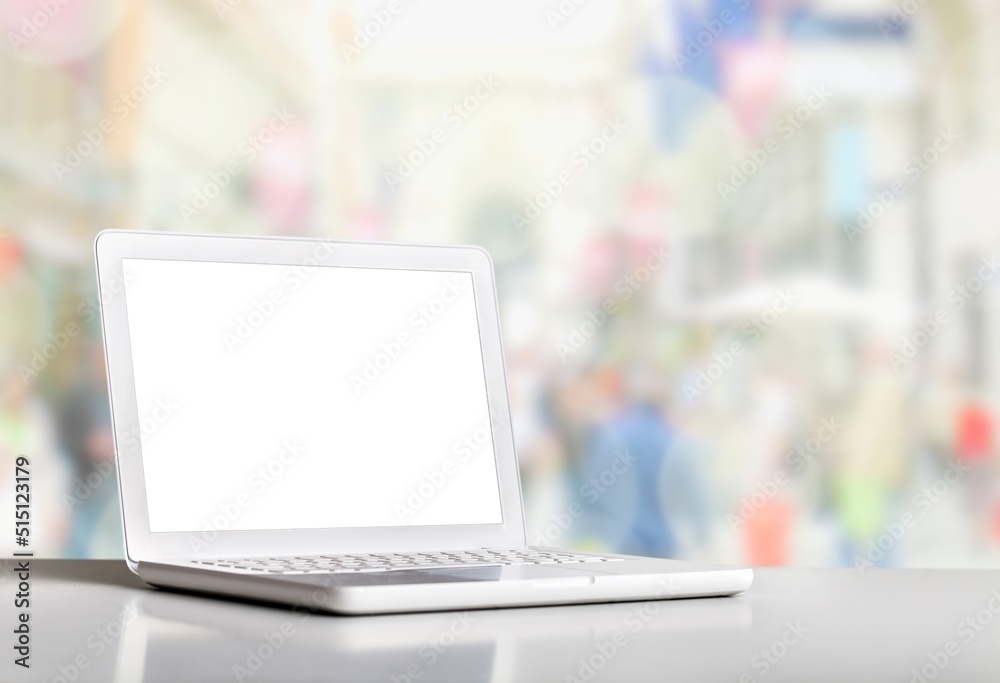 Fototapeta premium Laptop displaying a blank screen on the desk