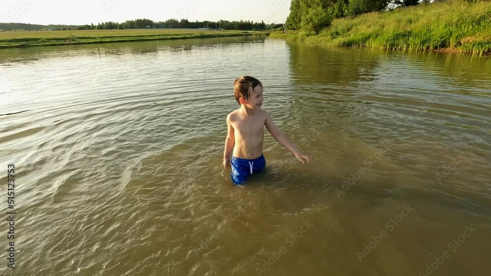 Overjoyed male kid splashing water swimming local countryside lake enjoy happy childhood slow motion Overjoyed male kid splashing water swimming local countryside lake enjoy happy childhood slow motion