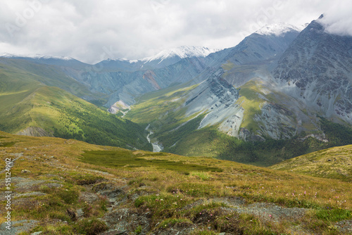 Aerial view over Altai mountains from Karaturek Pass on the way to Belukha mountain with blue sky with clouds. Altai region, Siberia, Russia