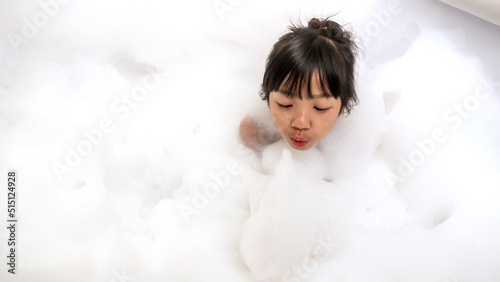 Asian girls having fun in a white bubble bath