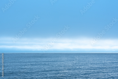 Nature background with blue sea against cloudy sky
