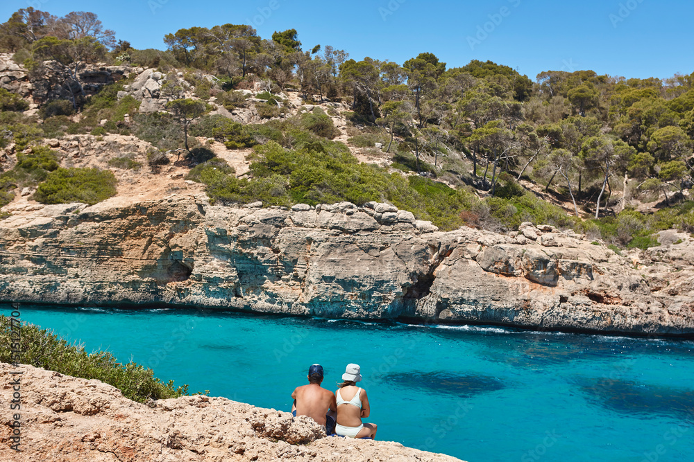 Summer in Spain. Couple relaxing mediterranean turquoise water in Mallorca
