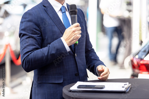Business person giving speech at opening ceremony or media event. Public speaking.