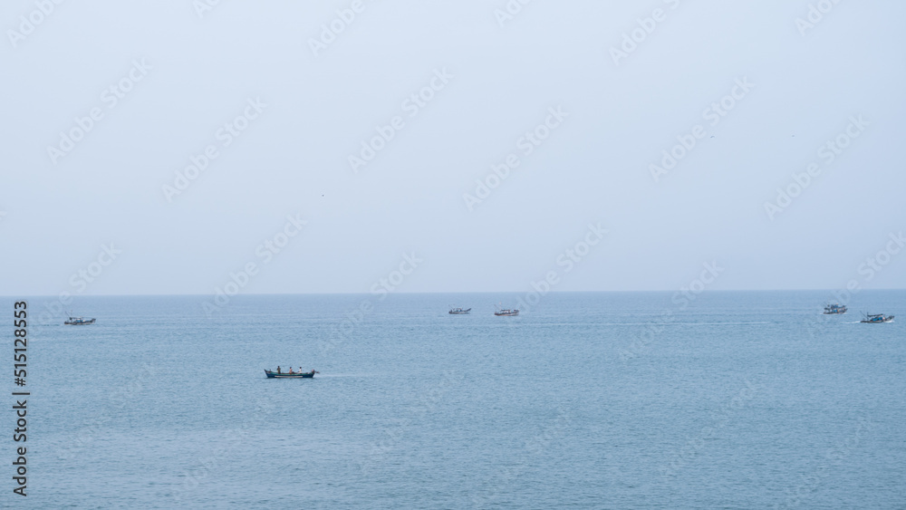 Fishing boats filled in a calm day with clear sky
