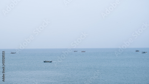 Fishing boats filled in a calm day with clear sky