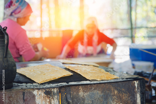 Cooking Traditional Turkish food gozleme with cheese flatbread on an iron oven photo