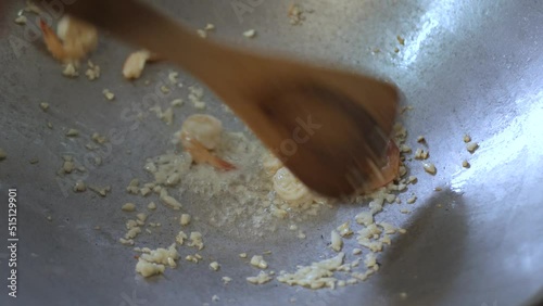 frying fresh shrimp with chopped garlic in pan preparing for cooking padthai street food photo