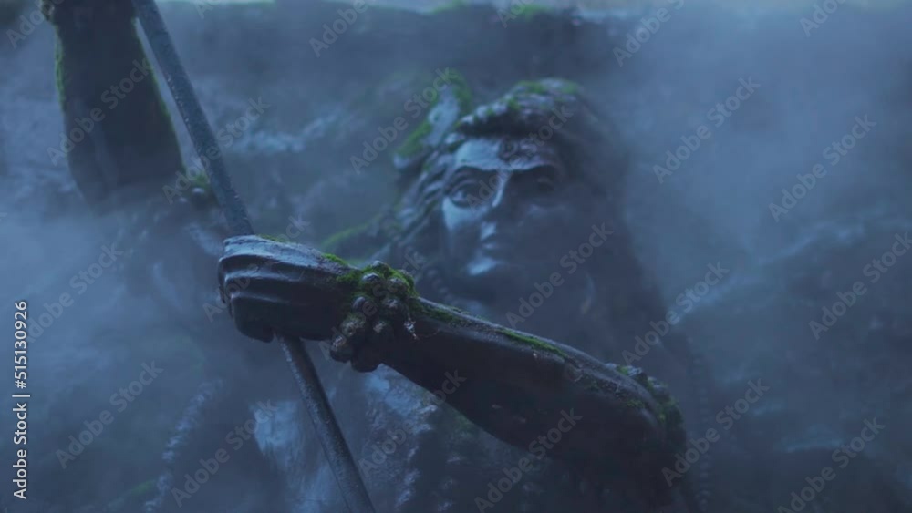 Closeup slow motion shot of fog around the statue of Lord Shiva at Manikaran Shiva Temple at Manikaran near Kasol in Himachal Pradesh, India. Fog due to water vapour of the hot water springs near it. 