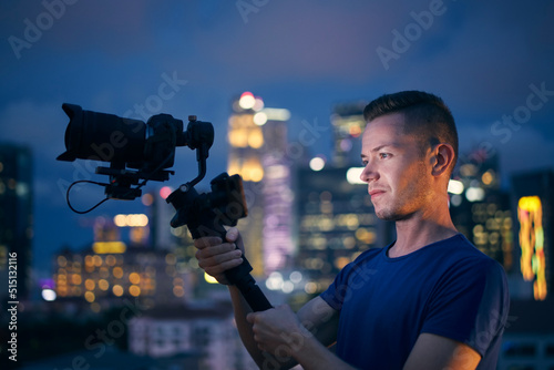 фотографія Man filming with camera and gimbal