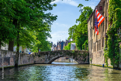 Historic houses with the city flag of Bruges, Belgium