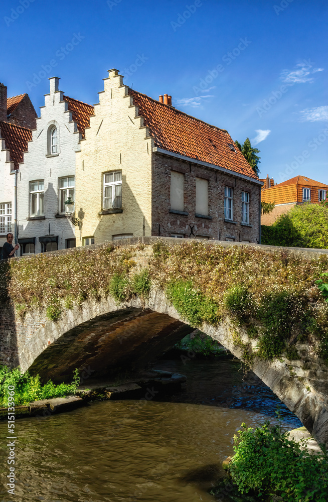 Fototapeta premium Bruges, Belgium vintage stone houses and bridge over canal