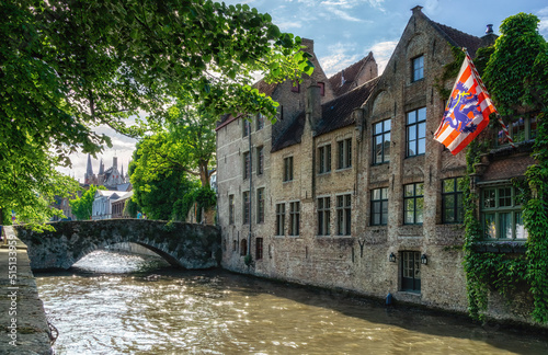 Historic houses with the city flag of Bruges, Belgium