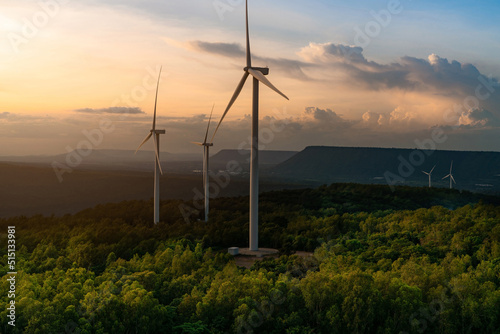 Wind energy. Wind power. Sustainable, renewable energy. Wind turbines generate electricity. Windmill farm on a mountain with sunset sky. Green technology. Renewable resource. Sustainable development.