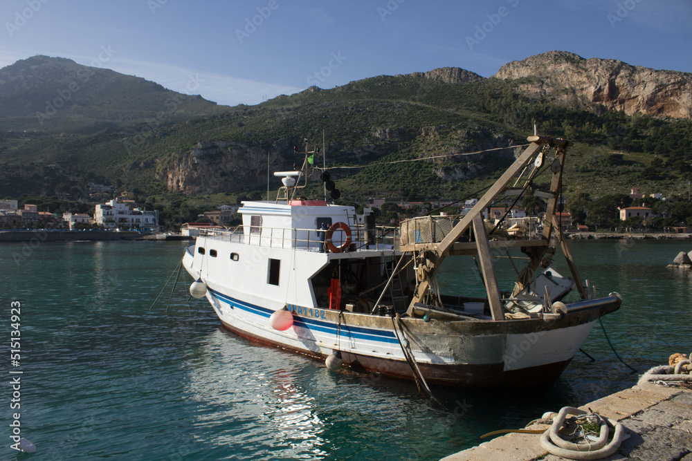 evocative image of fishing boats moored in the harbor in a small fishing village in Sicily, Italy
