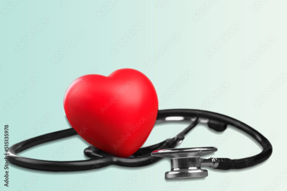 Red heart shape hand exercise ball with doctor physician's stethoscope. World heart health day. doctor day, world hypertension day Red heart shape hand exercise ball with doctor physician's stethoscope. World heart health day. doctor day, world hypertension day