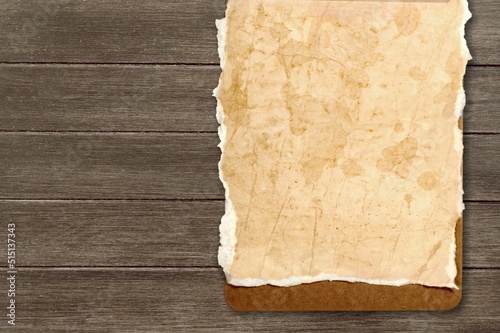Inspirational handmade paper against rustic weathered wood, storytelling and narration concept.