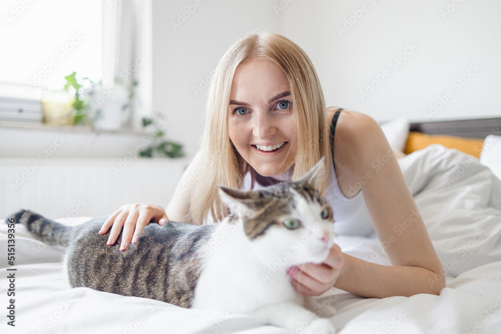 Female hugging sad tired cat in hands at home. Stay home stay safe. Love, care, adoption Female hugging sad tired cat in hands at home. Stay home stay safe. Love, care, adoption