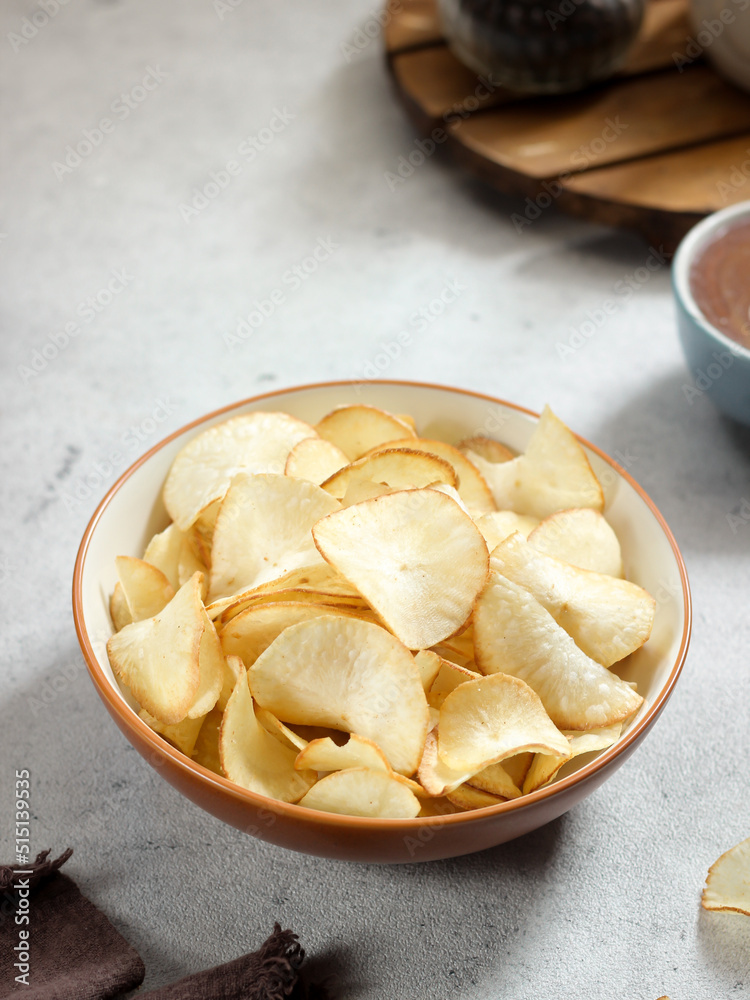 Keripik singkong. Cassava chips or tapioca chips is traditional snack from Java, made of cassava thinly sliced and fried. Keripik singkong. Cassava chips or tapioca chips is traditional snack from Java, made of cassava thinly sliced and fried.