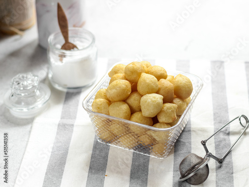 A bowl of Lokma (Turkish), loukoumades (Greeek ) with other names in other languages, are pastries made of leavened and deep fried dough. Selective focus photo