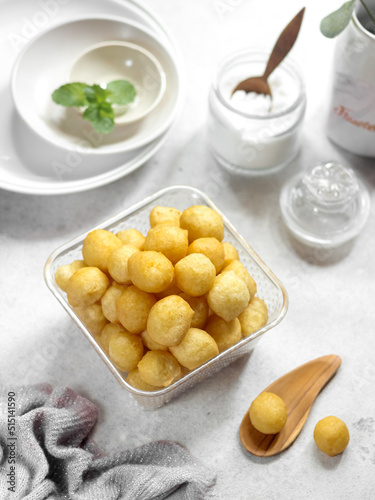 A bowl of Lokma (Turkish), loukoumades (Greeek ) with other names in other languages, are pastries made of leavened and deep fried dough. Selective focus photo