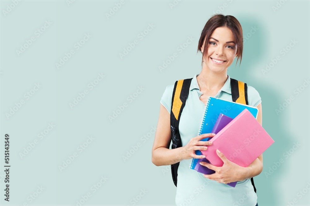 Young student woman wearing backpack and holding books Young student woman wearing backpack and holding books
