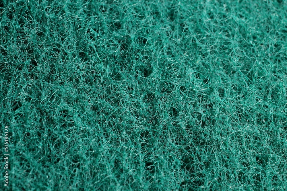 hard green sponge for washing dishes close-up hard green sponge for washing dishes close-up