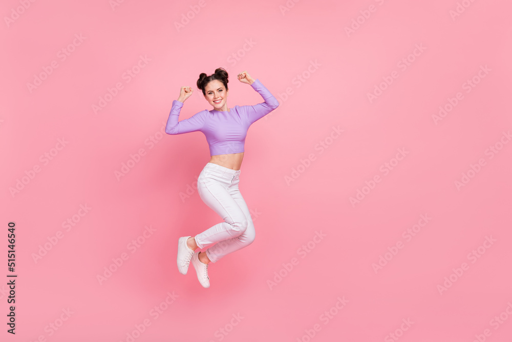 Full length photo of excited delighted girl raise fists celebrate triumph isolated on pink color background
