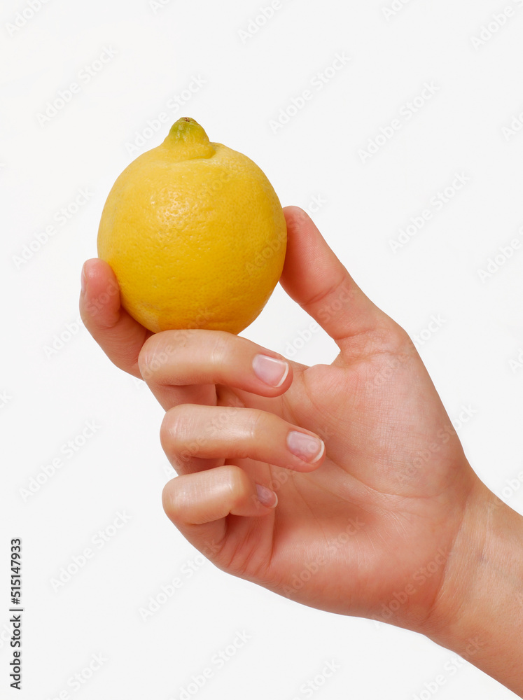 Female hand hold a yellow lemon fruit on white background. Female hand hold a yellow lemon fruit on white background.