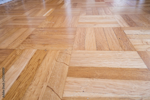 Brown wooden tile flooring or parquet in an apartment room. Low angle view, no people