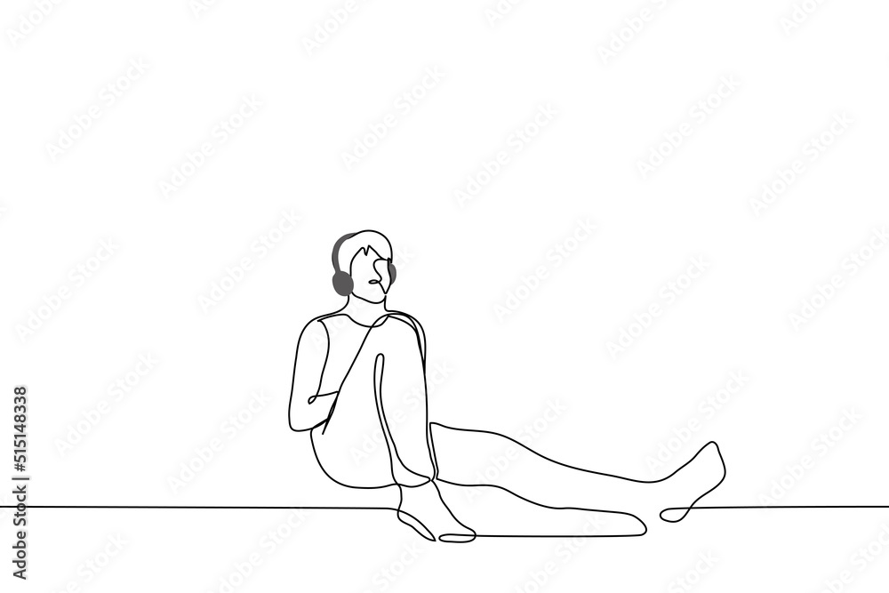 man in overhead headphones sits leaning against the wall - one line drawing vector. concept listening to music alone