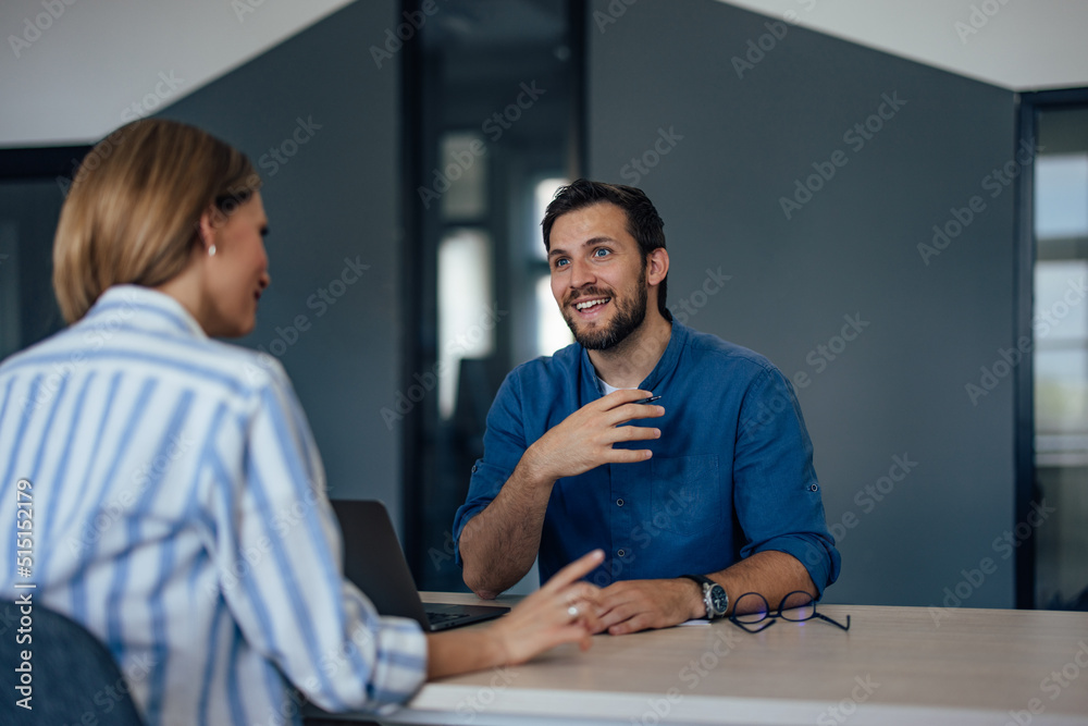 Smiling male boss explaining everything about the new job, talking to each other. Smiling male boss explaining everything about the new job, talking to each other.