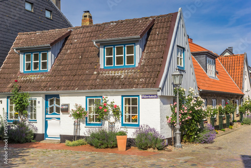 Little white house in Holm fishing village in Schleswig, Germany photo