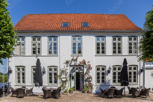 Front of a white restaurant in historic village Mogeltonder, Denmark