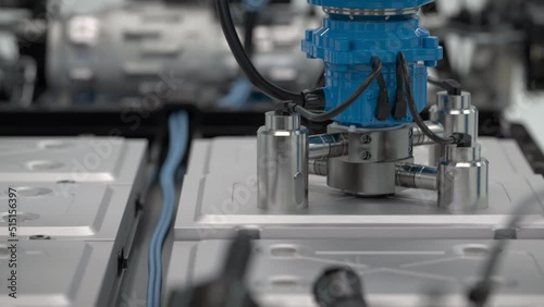 Modern electric car factory concept: Robots assembling the battery module of an electric car; fully automated production line with autonomous robots. Realistic high quality 3d animation. Close-up