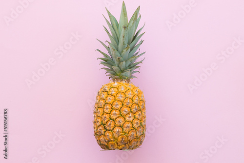 Ripe pineapple on a pink background