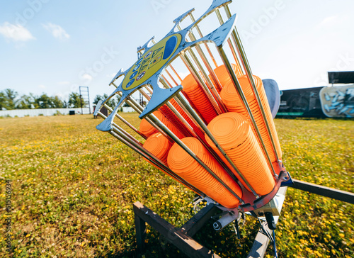 Close up plat machine with orange shooting plate for shooting-ground training on field with grass photo