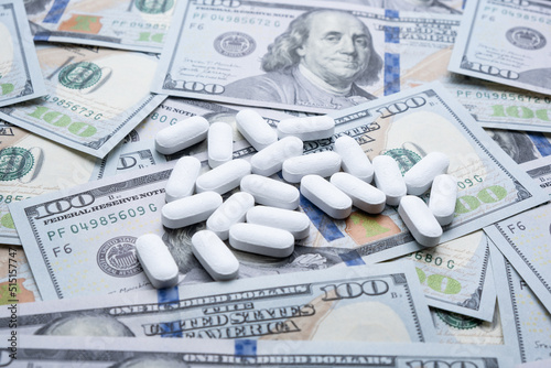 Pills on the background of the dollar close-up.