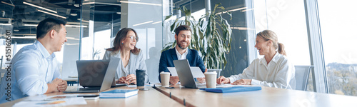 Creative business people working on project in office with panoramic view. Concept of teamwork