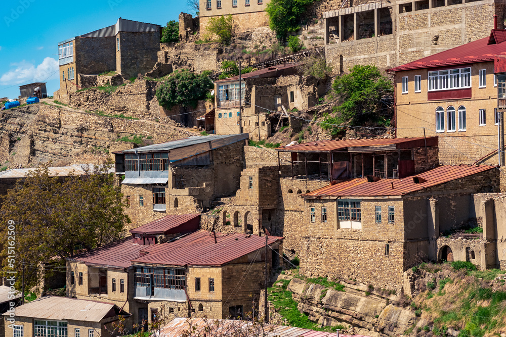 Obraz premium finished, under construction and destroyed houses of different times in the ancient mountain village of Chokh in Dagestan