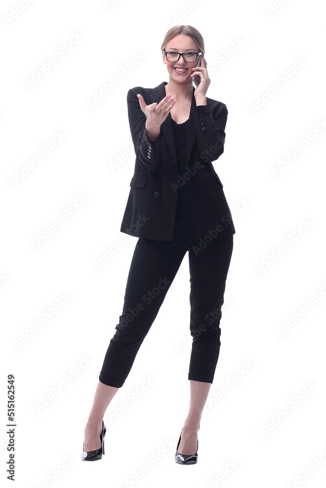 in full growth. smiling businesswoman talking on a smartphone in full growth. smiling businesswoman talking on a smartphone
