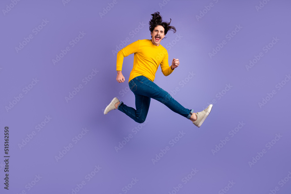 Full size portrait of excited satisfied person jumping have fun good mood isolated on purple color background