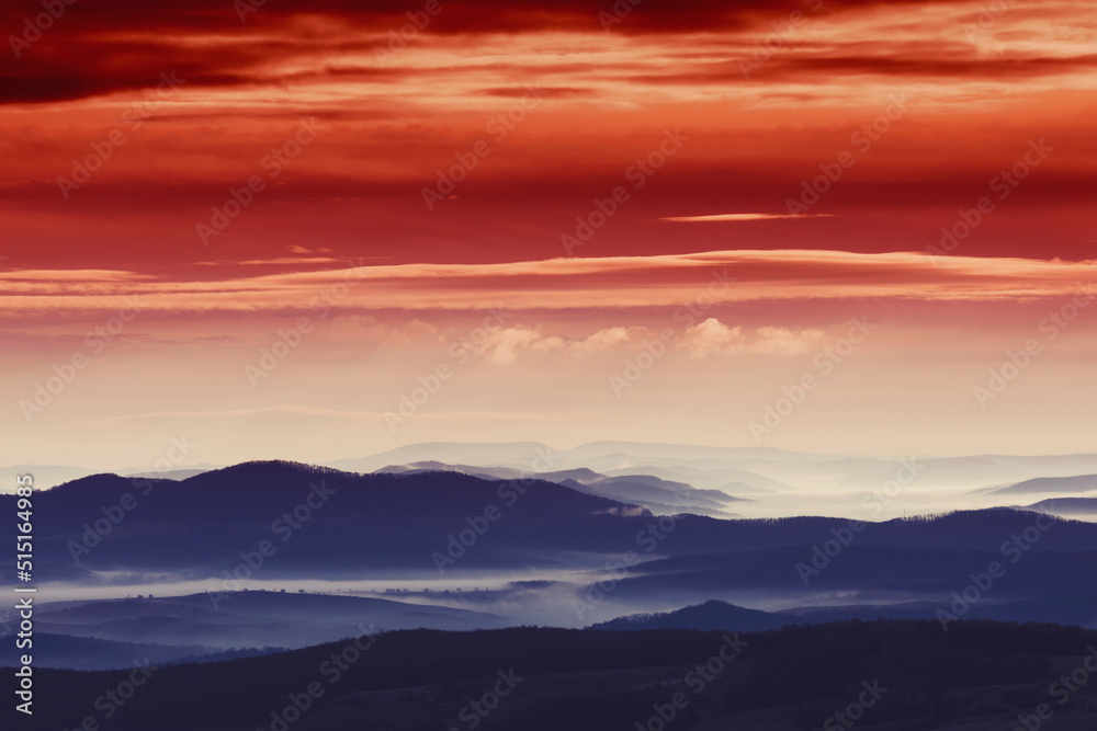sunset sky over foggy hills
