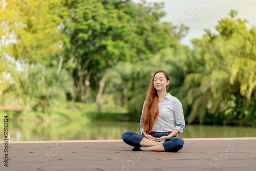 Asian woman wearing a white dress meditation near the canal