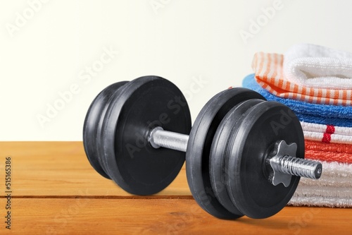 barbell weight and towel at desk. sport gym concept