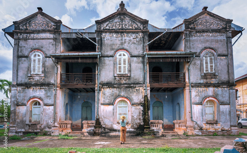 Thai female tourists gaze at ancient architecture French style village in Tharae Sakon Nakhon Landmark ancient of French in Thailand.