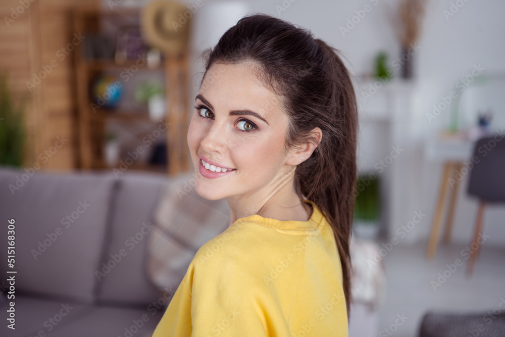 Profile portrait of satisfied glad girl look camera toothy smile enjoy pastime house indoors Profile portrait of satisfied glad girl look camera toothy smile enjoy pastime house indoors