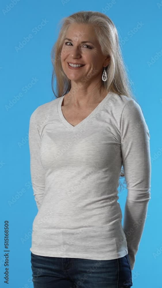Vertical video portrait of beautiful mature blond female with brown eyes, elegant make up smiling at camera, having confident happy facial expression, in good mood. Vertical video portrait of beautiful mature blond female with brown eyes, elegant make up smiling at camera, having confident happy facial expression, in good mood.