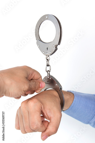 remove the handcuffs, the hand unfastens the handcuffed hand with a key, on an isolated white background photo